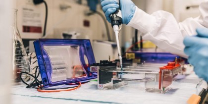 scientist in lab with pipette scaled