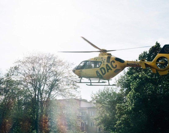 yellow helicopter lands in town scaled